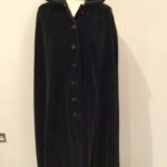 Vintage 70s Dereta, England black cotton velvet midi cape, collar, braid trim, slit pockets, free size